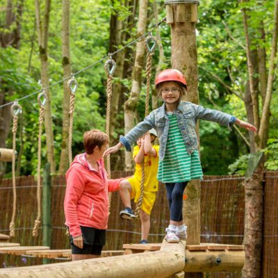 Little girl balancing in junior woodland