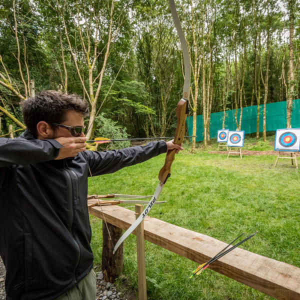Archery at Castlecomer Discovery Park Man shooting bow and arrow