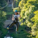 Man on zip line in the sunshine