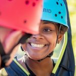 women smiling with helmet on