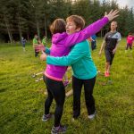 Group during team building exercise hugging