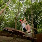 Girl on junior low ropes course