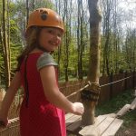 Child on junior ropes course smiling