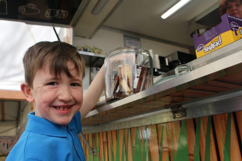 Child at canopy cafe taking chocolate